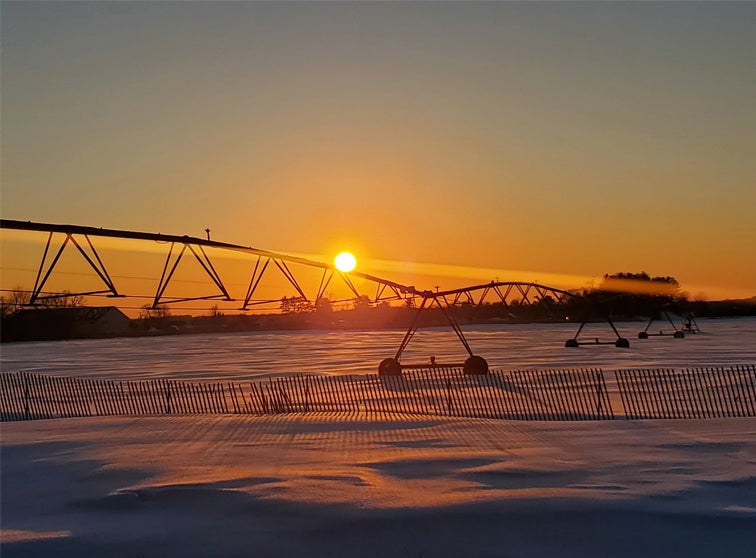 Irrigation system in a snow covered field. 