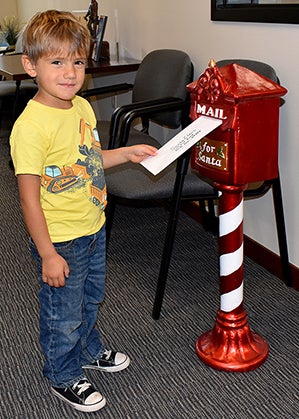 Boy mailing letter to Santa