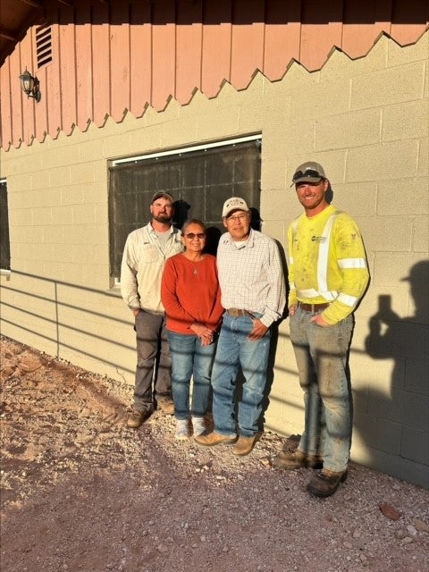 CWEC linemen Mack Yarbrough and Josh Wick with the homeowners who had electricity brought to their home via the Light Up Navajo Project.