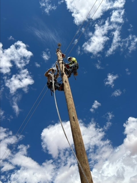 While spending a week working on the Light Up Navajo Project, CWEC linemen Mack Yarbrough and Josh Wick climbed a lot of power poles.
